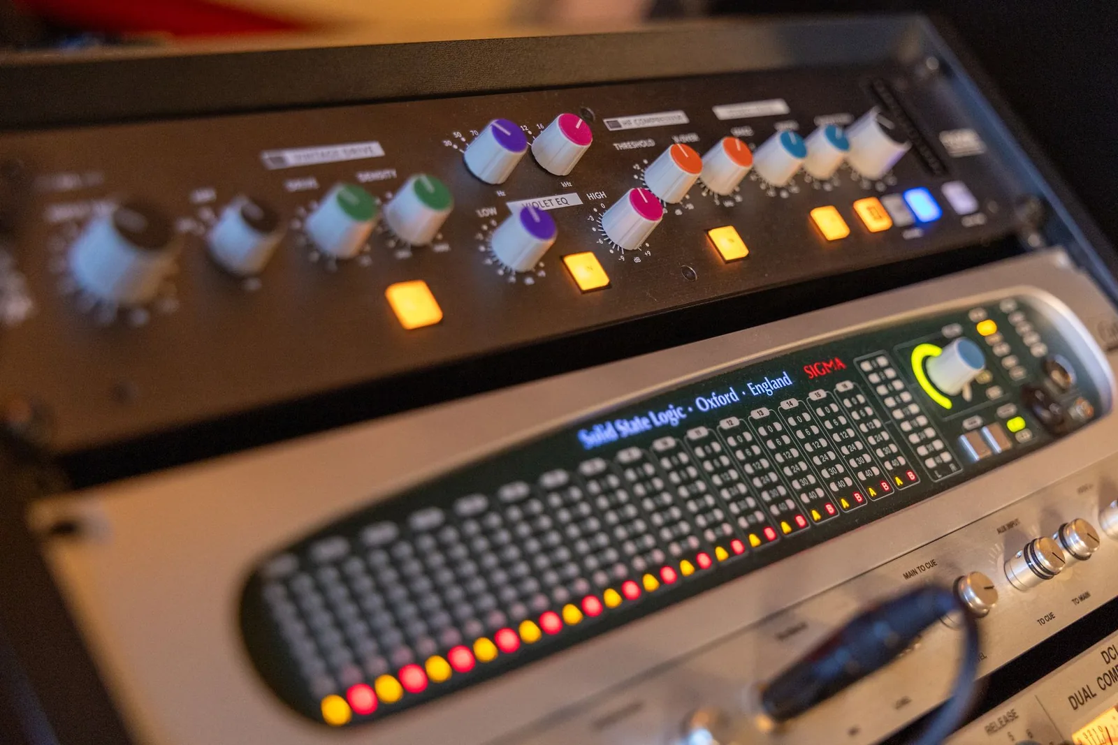 Photo of two rack-mounted Solid State Logic units: an SSL Fusion stereo processor on top and an SSL Sigma SuperAnalogue summing engine below.